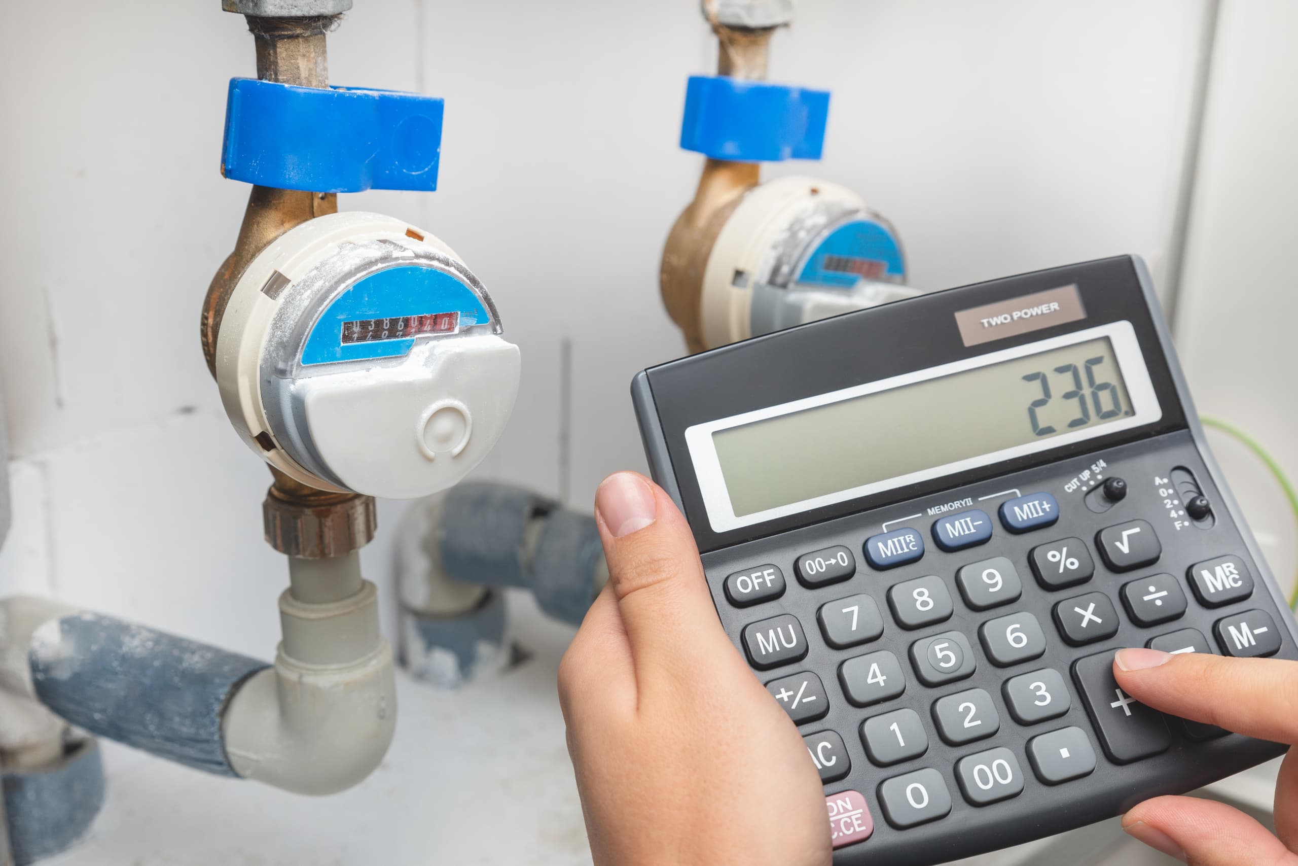man calculating business water rates with calculator