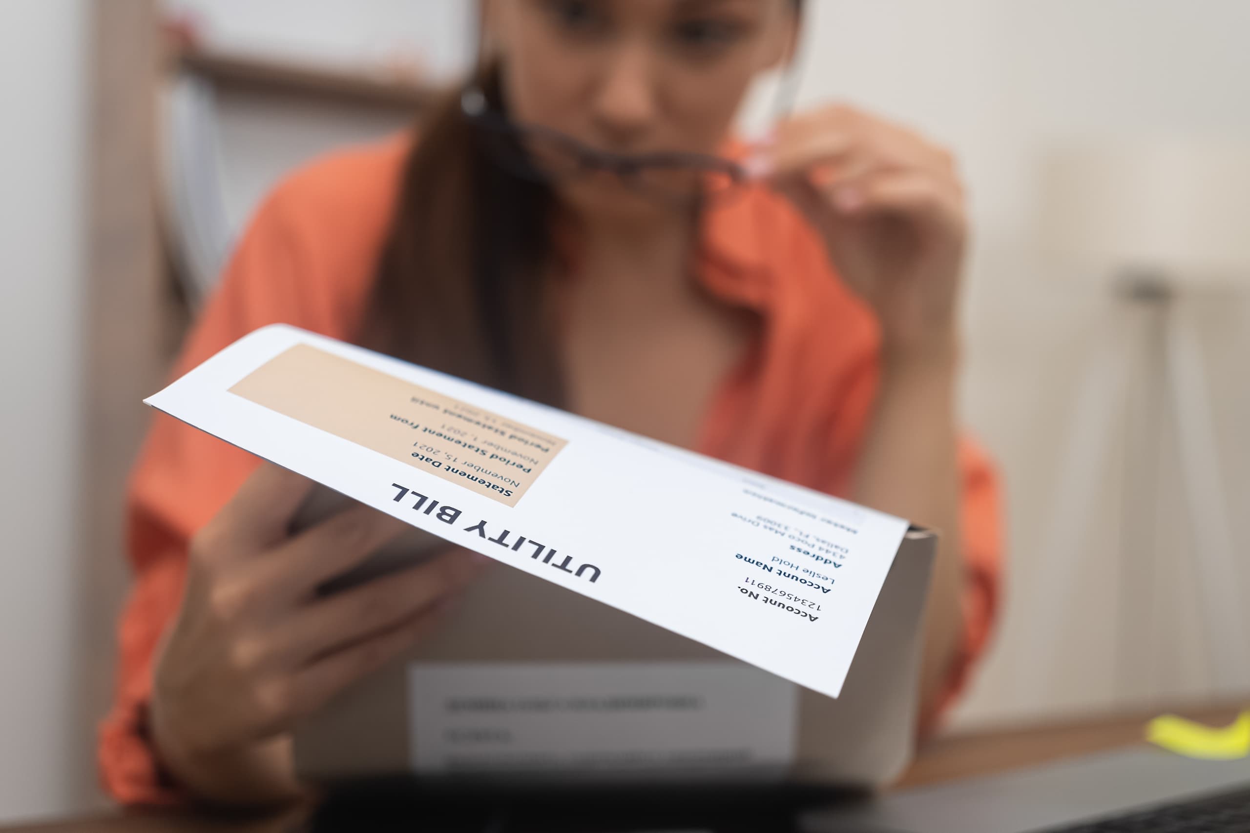 woman looking and analysing her home utility bill